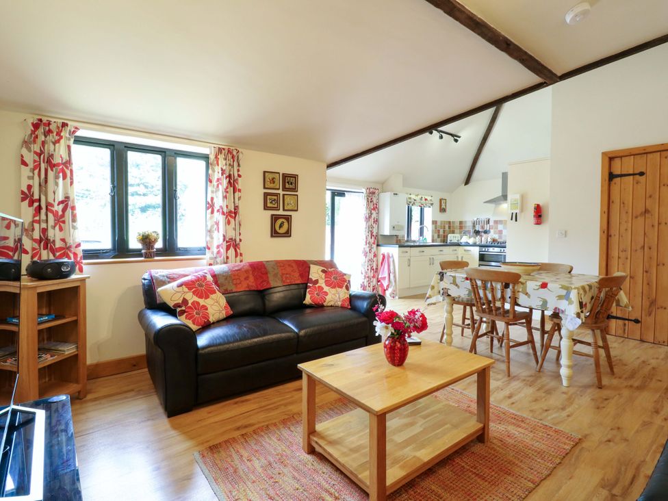 A living room with a sofa and coffee table at The Golden Cross in Mendham near Harleston