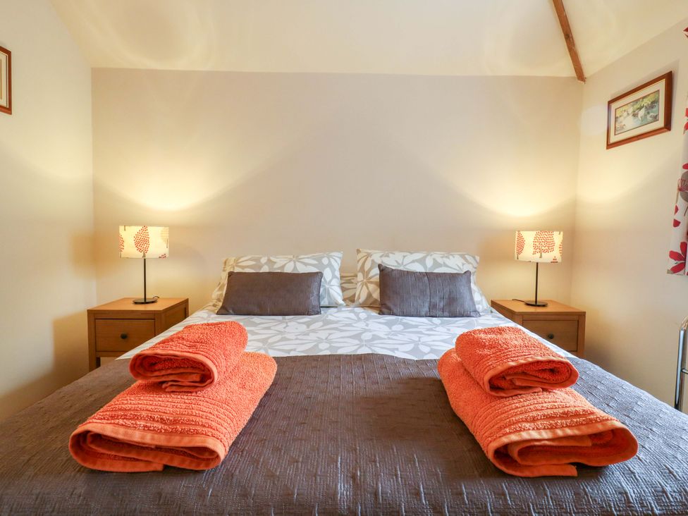 A bedroom with a bed and bedside tables at The Golden Cross Mendham near Harleston