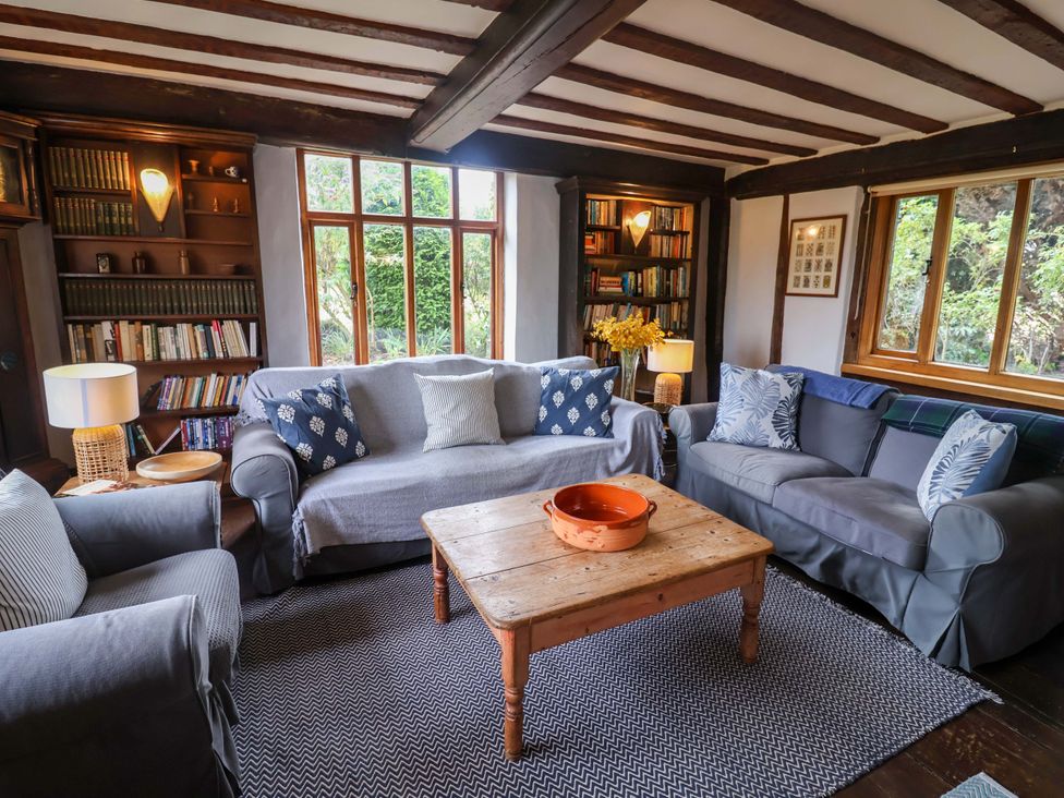 A living room with sofas and a coffee table at Keirs Cottage in Carlton Colville