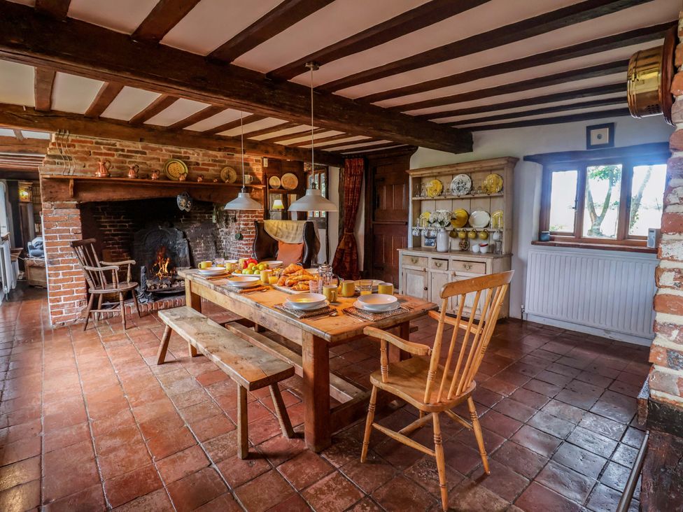 A dining room with a table and chairs at Keirs Cottage in Carlton Colville
