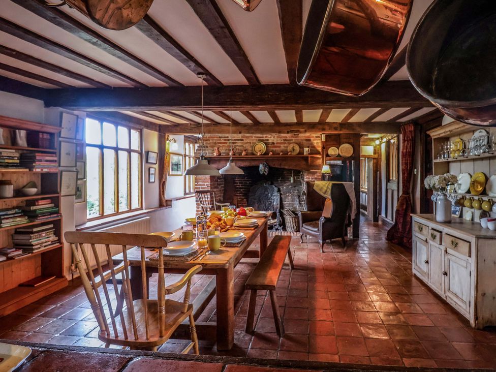 A dining room with a table set for meals at Keirs Cottage in Carlton Colville