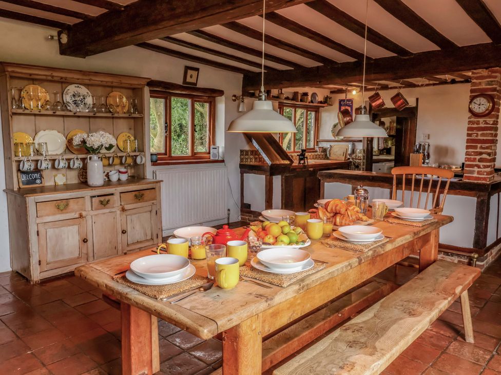 A kitchen with a dining table set for breakfast at Keirs Cottage in Carlton Colville