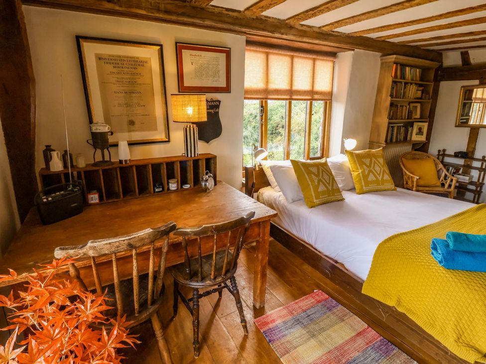 A bedroom with a bed and desk at Keirs Cottage in Carlton Colville