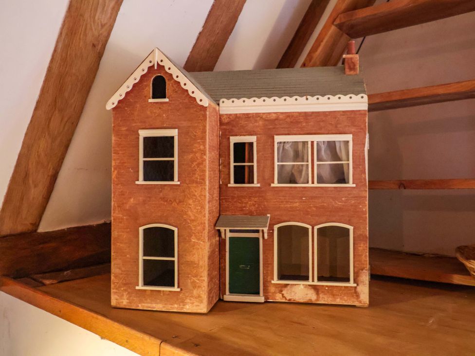 A dollhouse on a shelf at Keirs Cottage in Carlton Colville