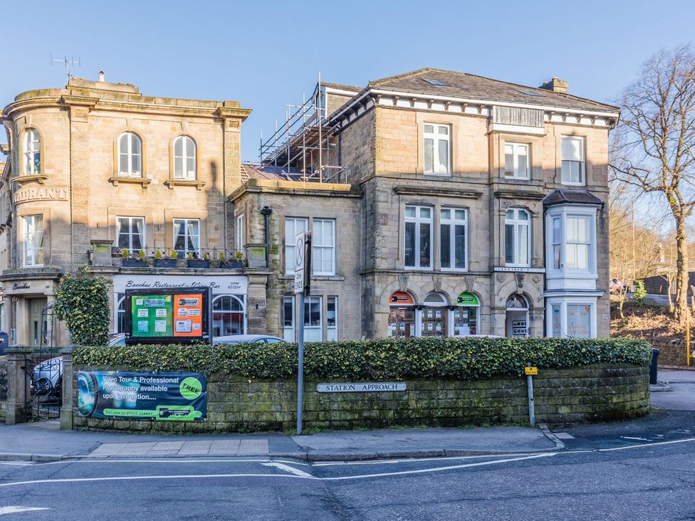 A restaurant building with signage and windows at The Crows Nest in Buxton