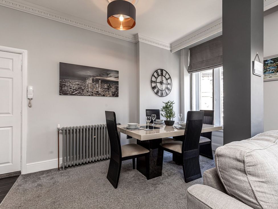 A dining room with a table and chairs at The Crows Nest in Buxton