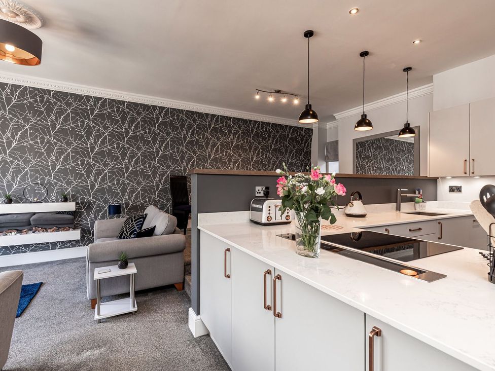 A kitchen with a sofa and a coffee table at The Crows Nest in Buxton