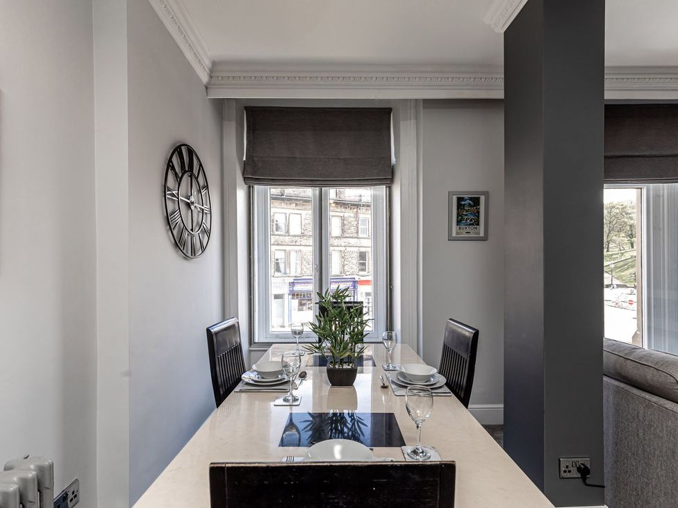 A dining room with a table and chairs at The Crows Nest in Buxton