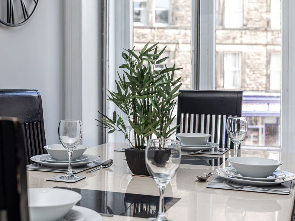 A dining room with a table set for meals at The Crows Nest in Buxton