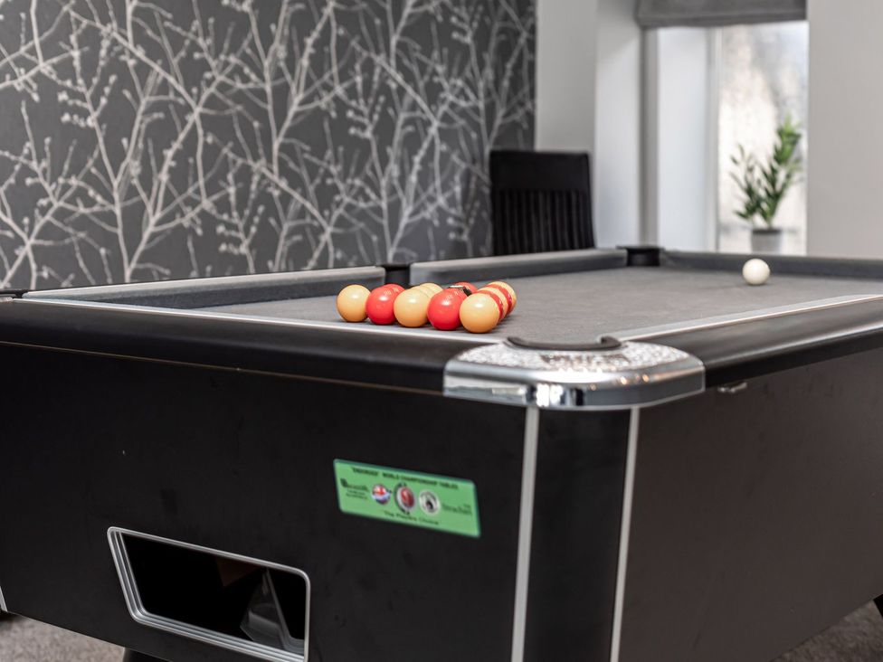 A pool table with billiard balls in a game room at The Crows Nest in Buxton