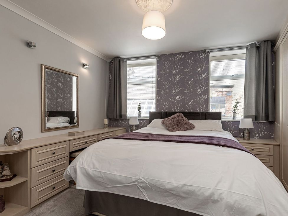 A bedroom with a bed and a dresser at The Crows Nest in Buxton