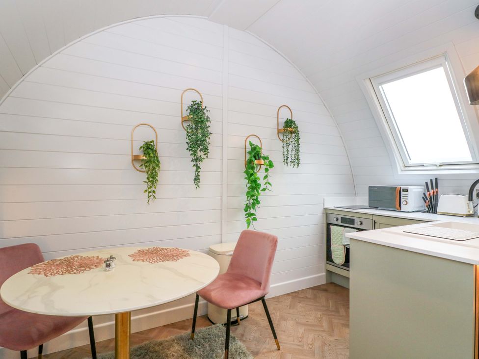 A kitchen with a table and two chairs at Crofters Suite in 