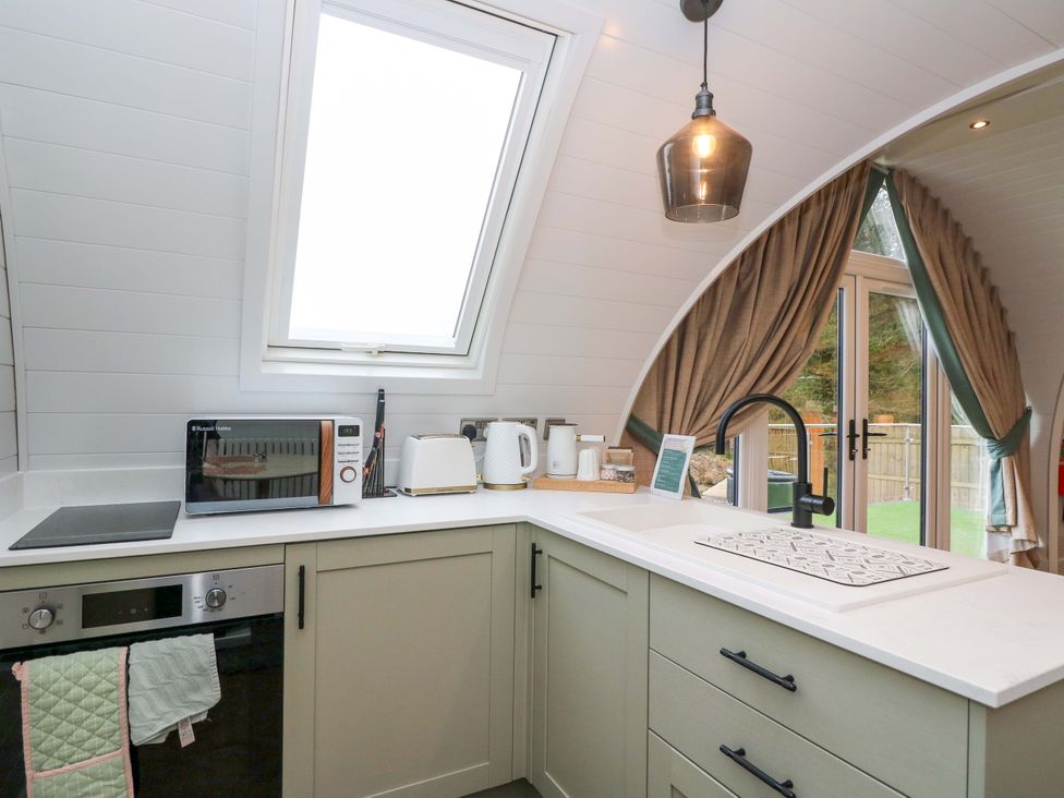 A kitchen with a microwave, kettle, and oven in Crofters Suite at 