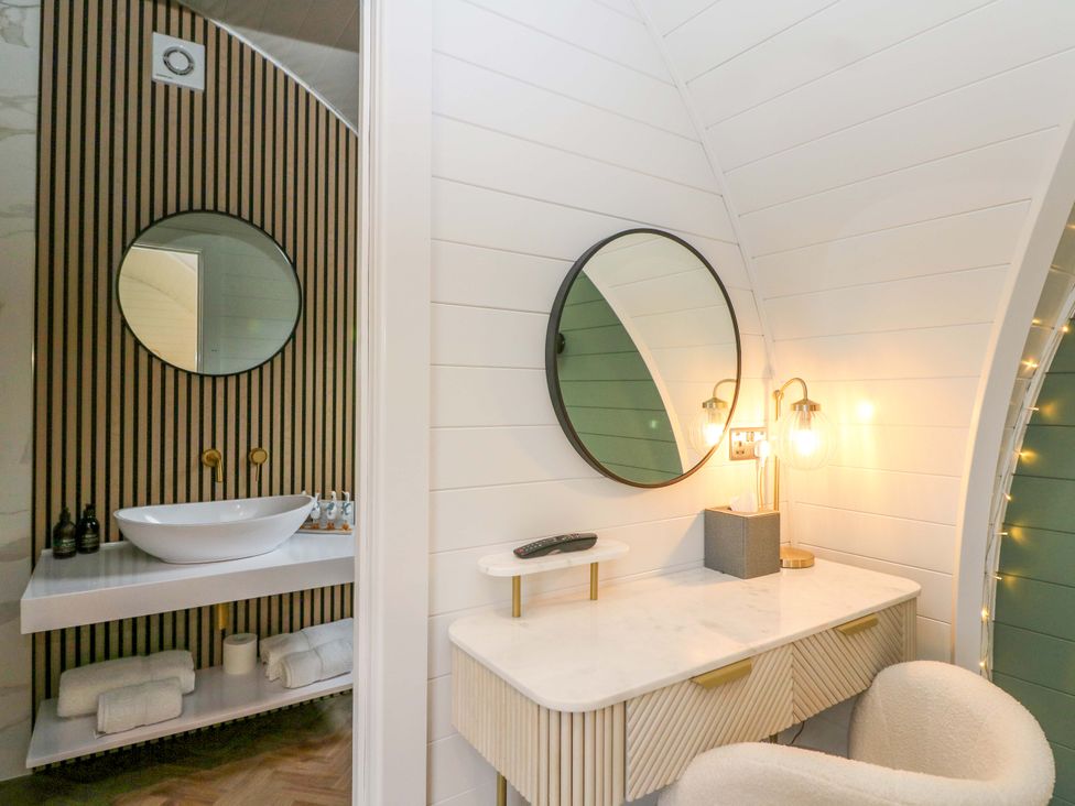A bathroom featuring a sink and mirror at Crofters Suite