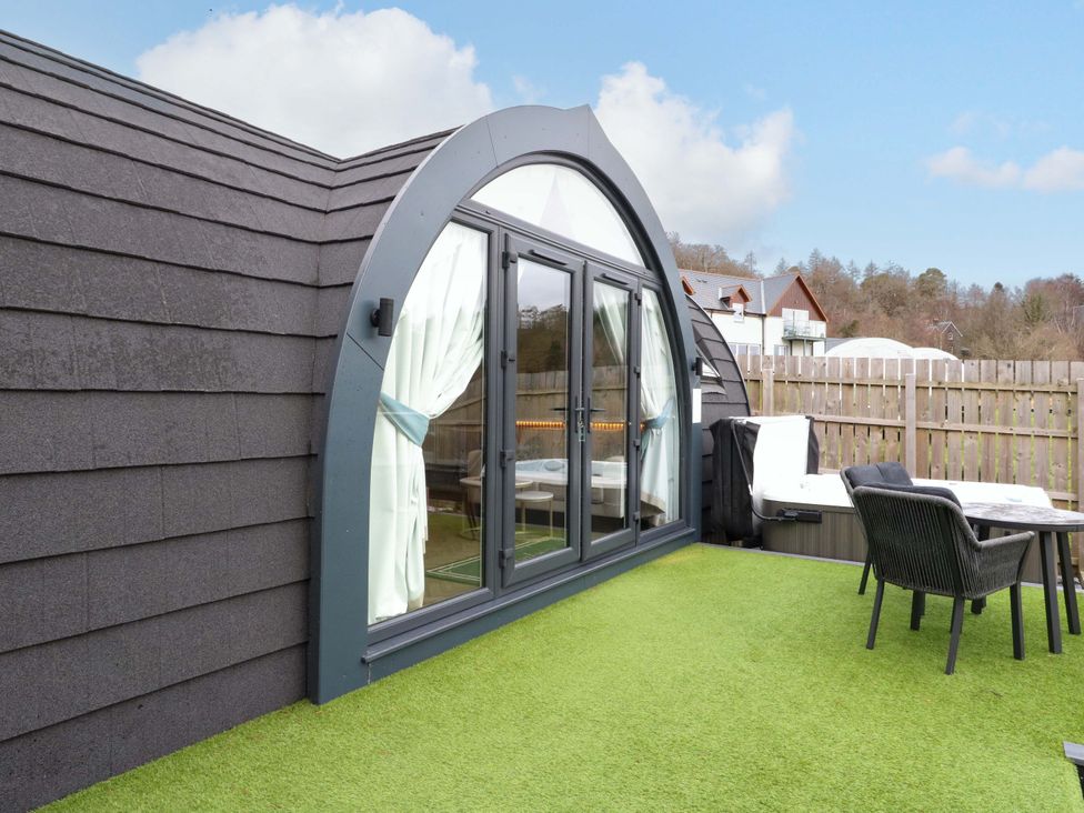 An outdoor area with a window and seating at Crofters Suite