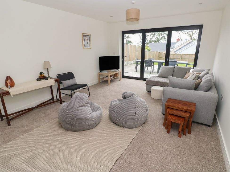 A living room with a sofa and TV at Ty Landsker in Milford Haven