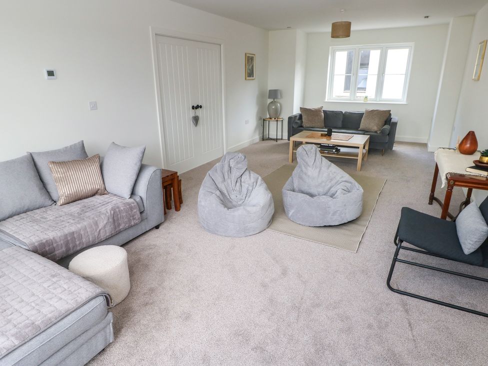 A living room with bean bags and a sofa at Ty Landsker in Milford Haven