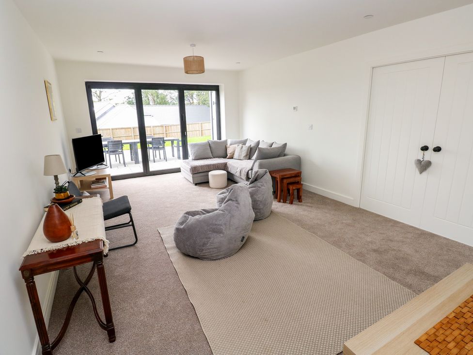 A living room with a sofa and television at Ty Landsker in Milford Haven