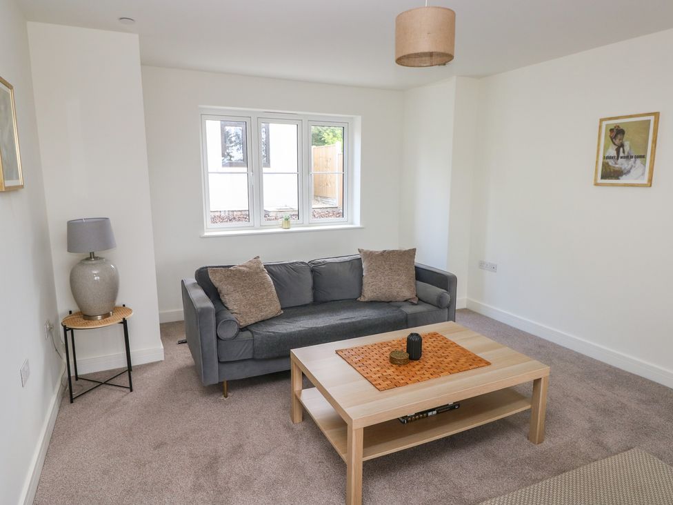 A living room with a sofa and table at Ty Landsker in Milford Haven