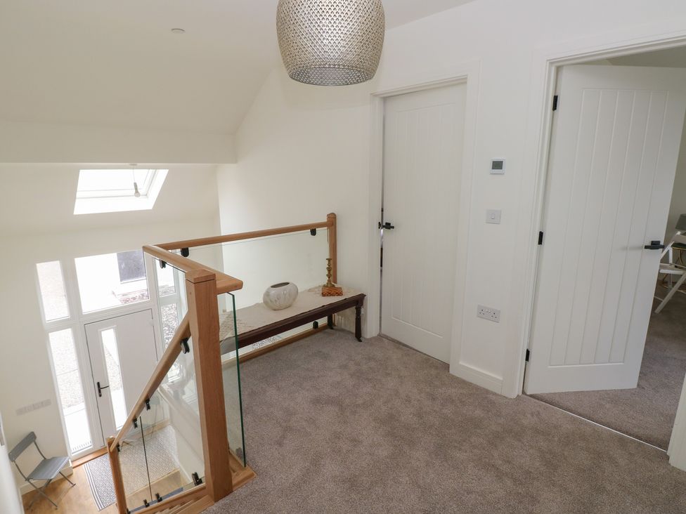 A hallway with stairs and doors at Ty Landsker Milford Haven