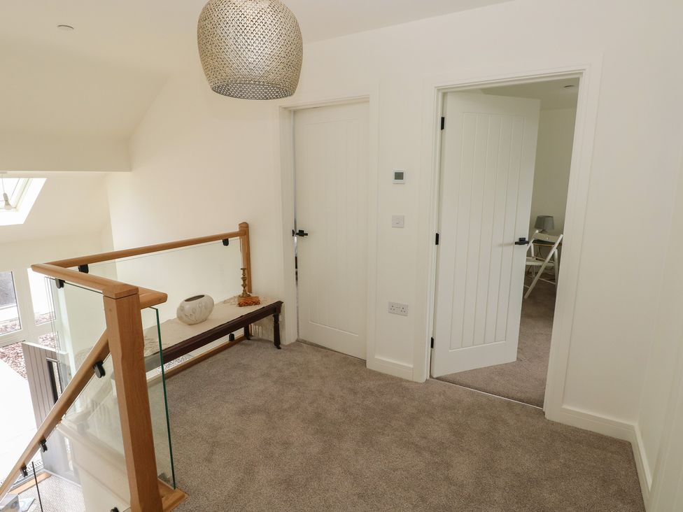 A landing area with a staircase and decorative features at Ty Landsker in Milford Haven