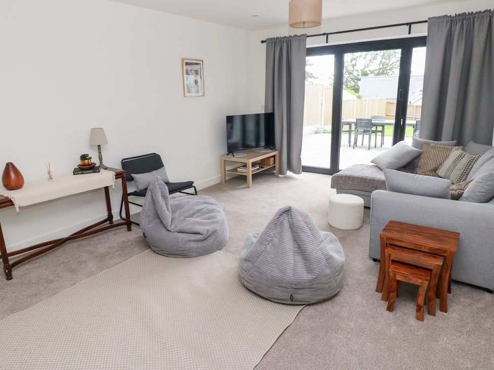 A living room with a sofa and television at Ty Landsker in Houghton near Neyland