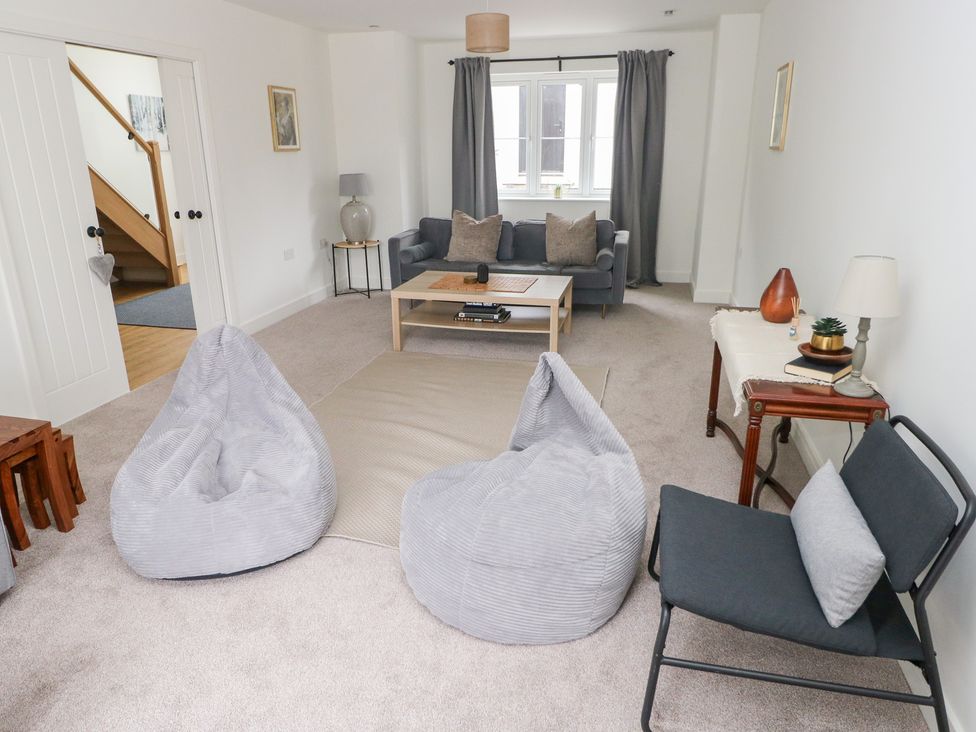 A living room with bean bags and a sofa at Ty Landsker Houghton near Neyland