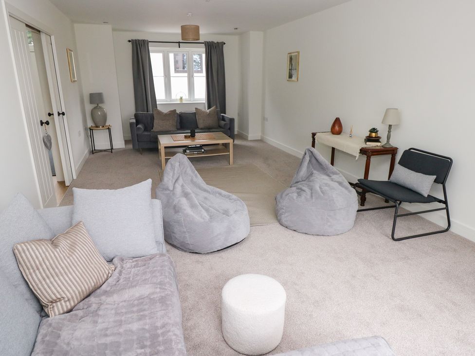A living room with a coffee table and bean bags at Ty Landsker Houghton near Neyland
