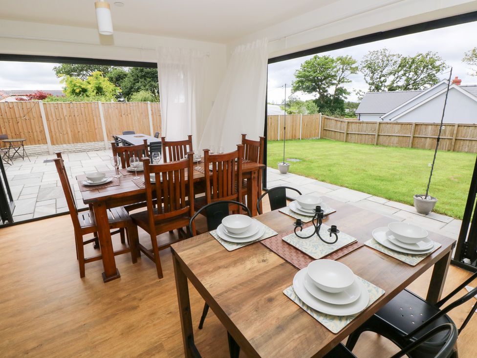 A dining room with tables and chairs at Ty Landsker in Houghton near Neyland