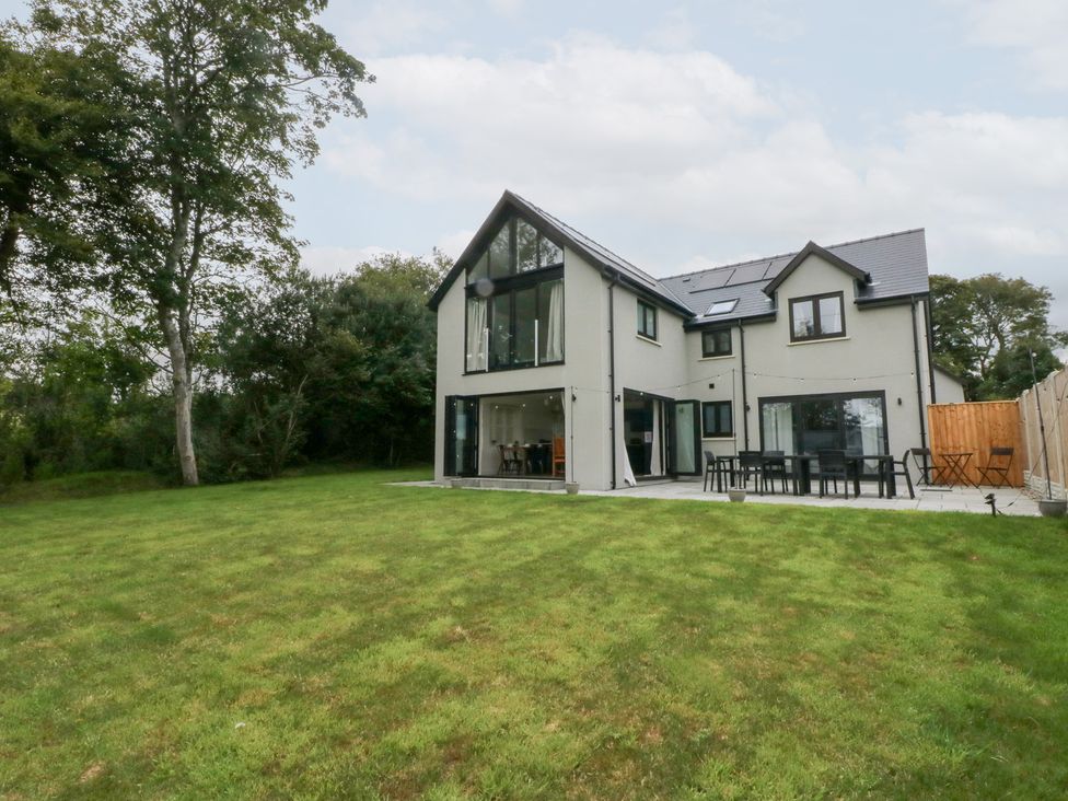 A house with a garden and patio area at Ty Landsker Houghton near Neyland