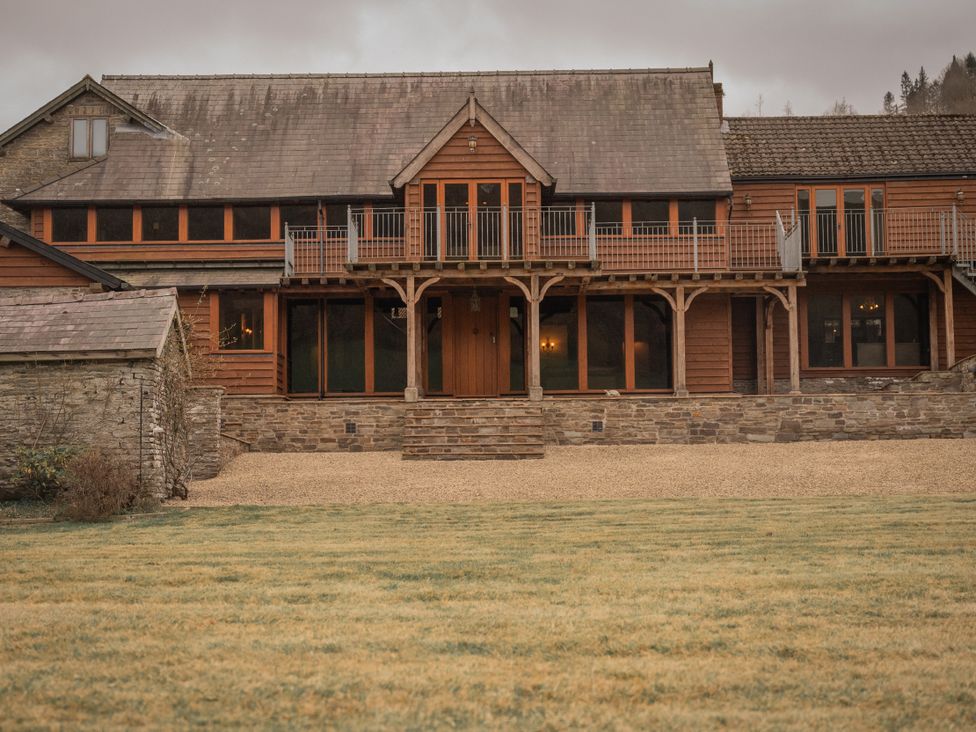 A house with a balcony and stone steps at Stud Farm House Bleddfa near Knighton