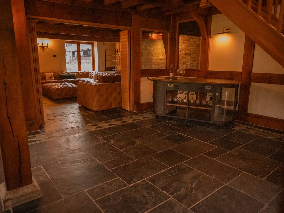A living room with a bar cabinet and sofa at Stud Farm House Bleddfa near Knighton
