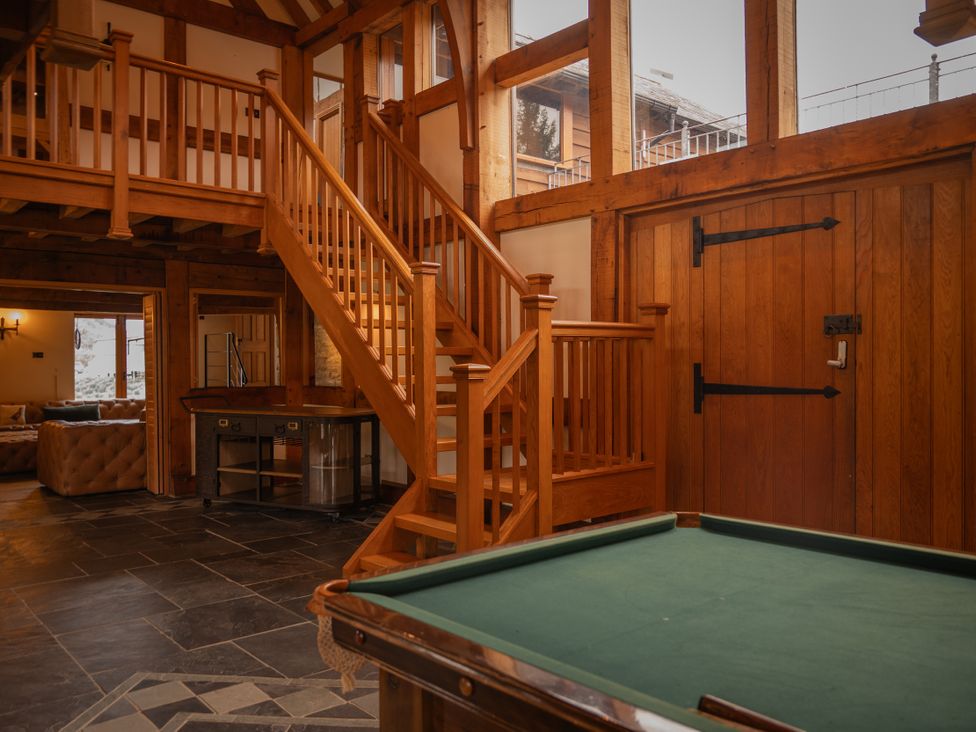 A living room with a pool table and staircase at Stud Farm House Bleddfa near Knighton