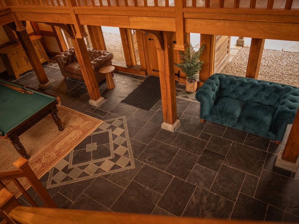 A living room with a pool table and sofas at Stud Farm House Bleddfa near Knighton