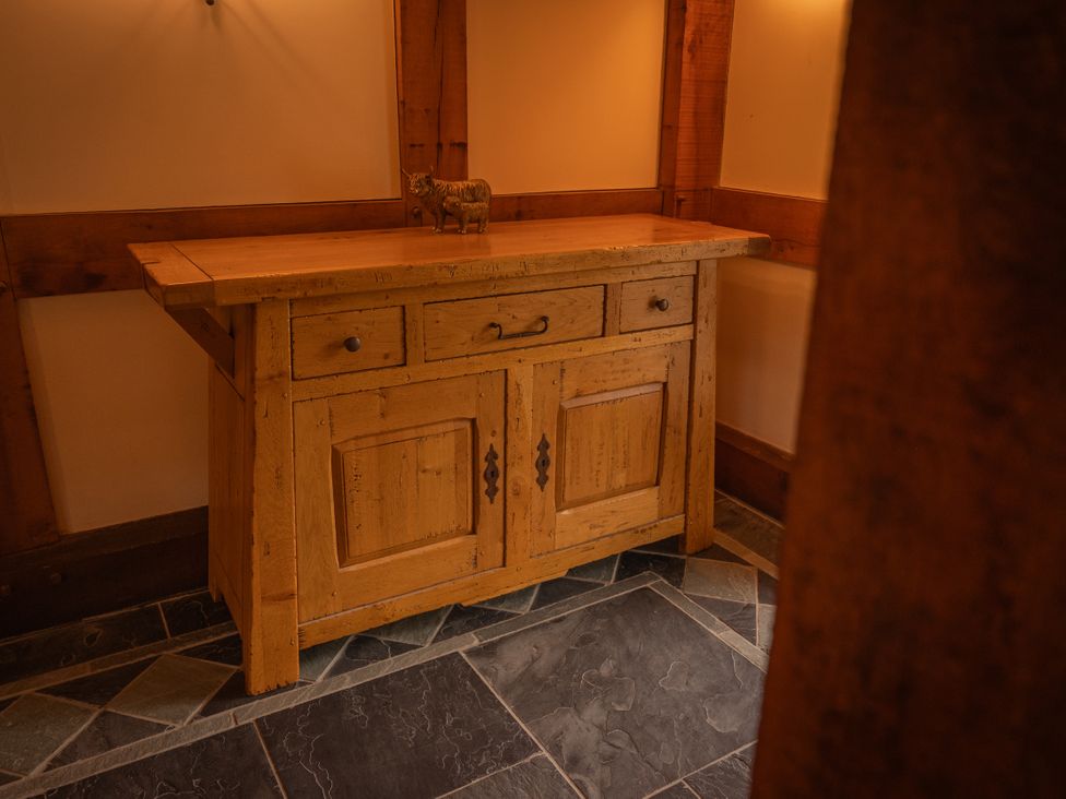 A wooden console table with drawers in a hallway at Stud Farm House Bleddfa near Knighton