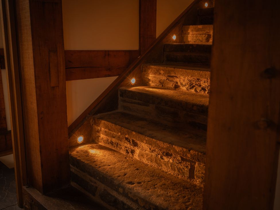 A staircase with stone steps and lights at Stud Farm House Bleddfa near Knighton