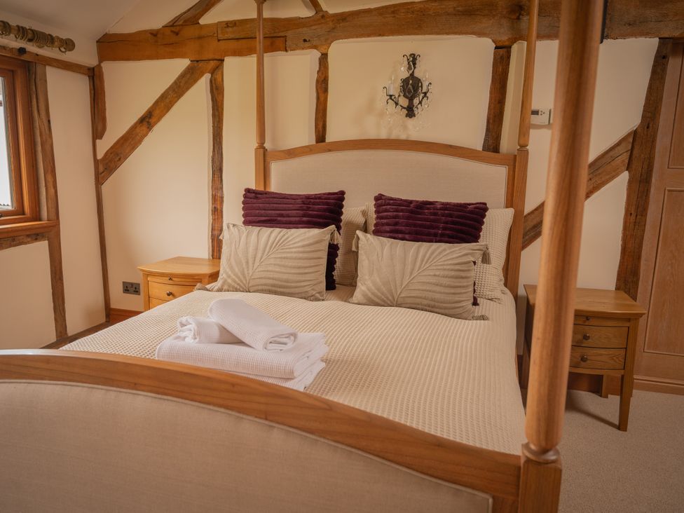 A bedroom with a bed and pillows at Stud Farm House in Bleddfa near Knighton