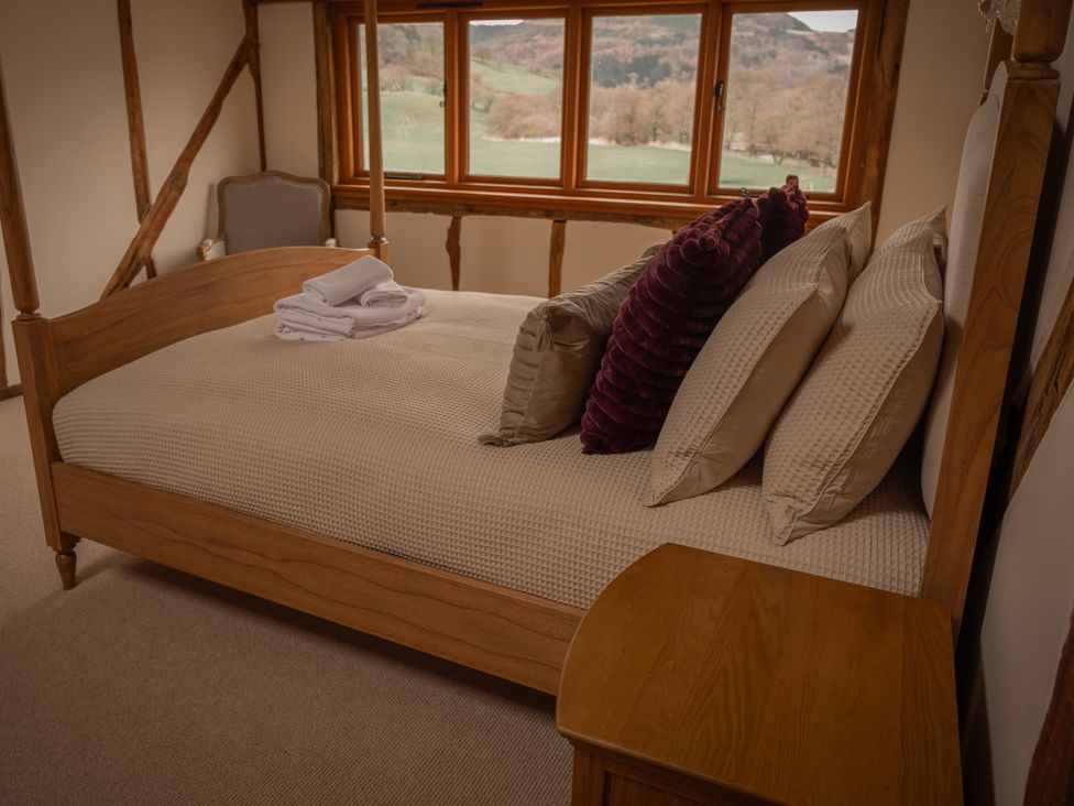A bedroom with a bed and pillows at Stud Farm House Bleddfa near Knighton