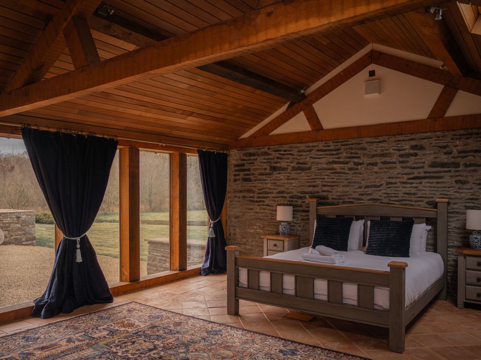 A bedroom with a bed and nightstands at Stud Farm House in Bleddfa near Knighton
