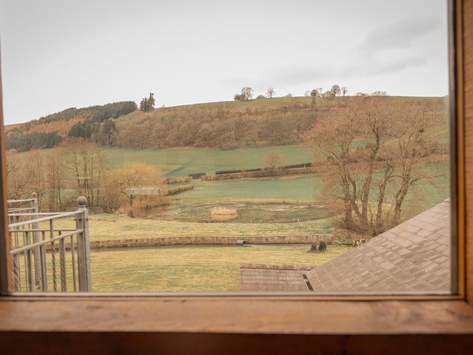 A view of hills and trees from a window at Stud Farm House, Bleddfa near Knighton