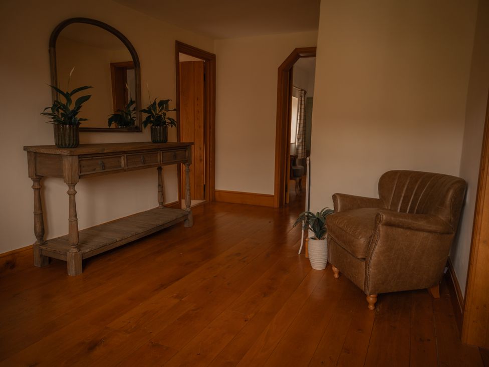 A hallway with a console table and chair at Stud Farm House Bleddfa near Knighton