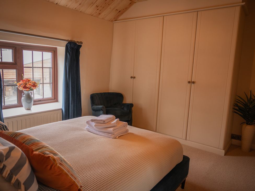 A bedroom with a bed and wardrobe at Stud Farm House Bleddfa near Knighton