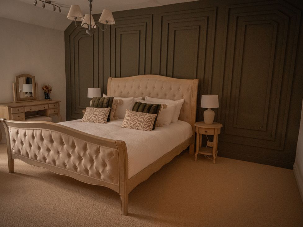 A bedroom with a bed and a desk at Stud Farm House Bleddfa near Knighton
