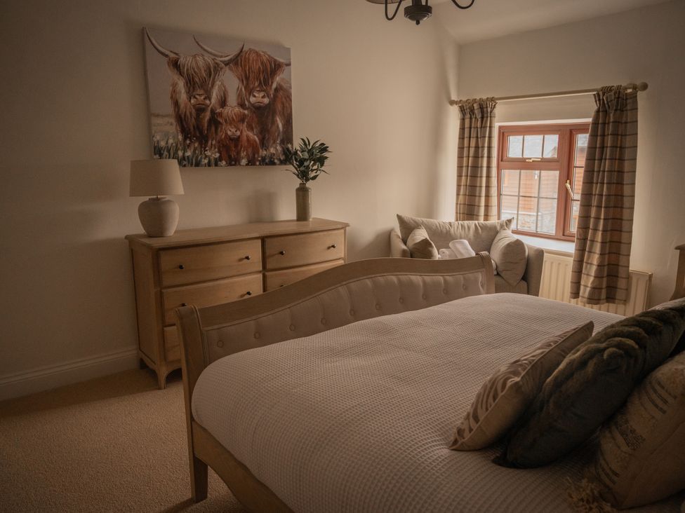 A bedroom with a bed and dresser at Stud Farm House in Bleddfa near Knighton