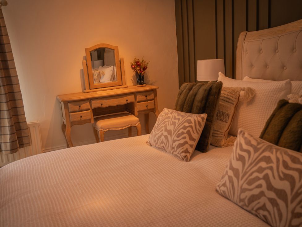 A bedroom with a bed and vanity table at Stud Farm House Bleddfa near Knighton
