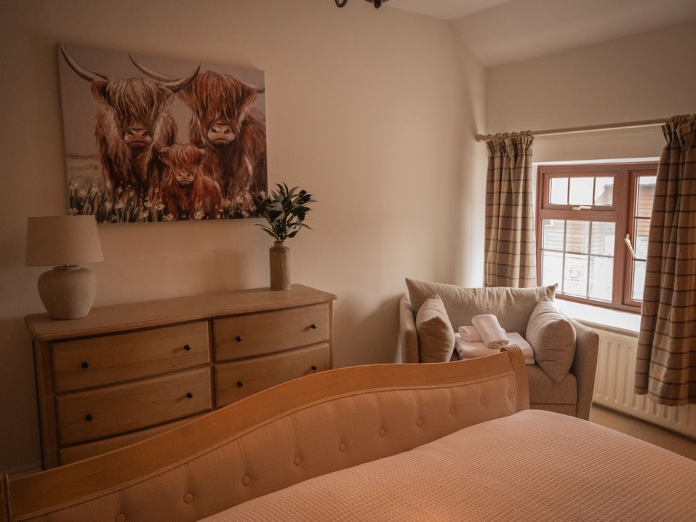 A bedroom with a bed and dresser at Stud Farm House in Bleddfa near Knighton