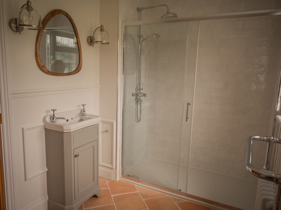 A bathroom with a sink and shower at Stud Farm House in Bleddfa near Knighton
