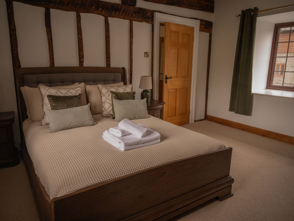 A bedroom with a bed and pillows at Stud Farm House in Bleddfa near Knighton