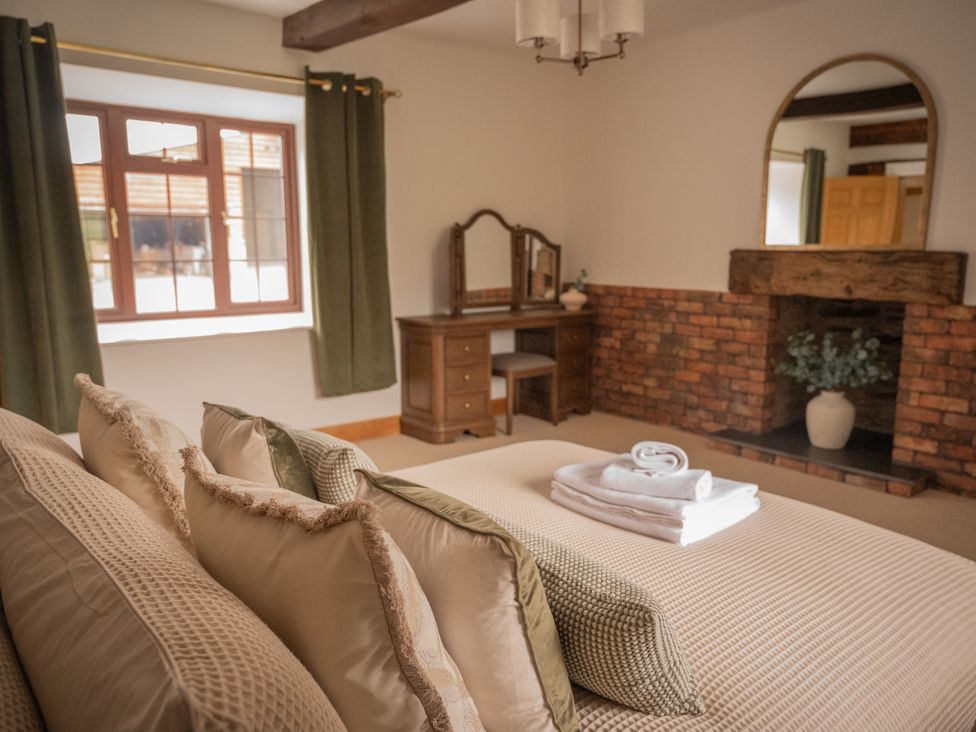 A bedroom with a bed and dresser at Stud Farm House in Bleddfa near Knighton