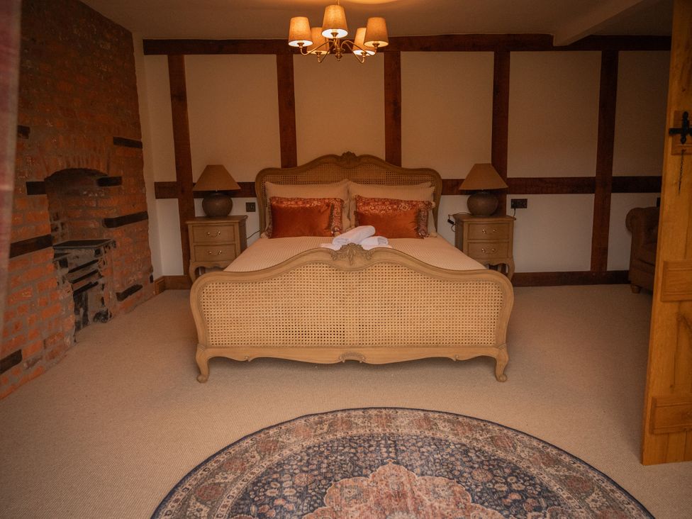 A bedroom with a bed and nightstands at Stud Farm House in Bleddfa near Knighton